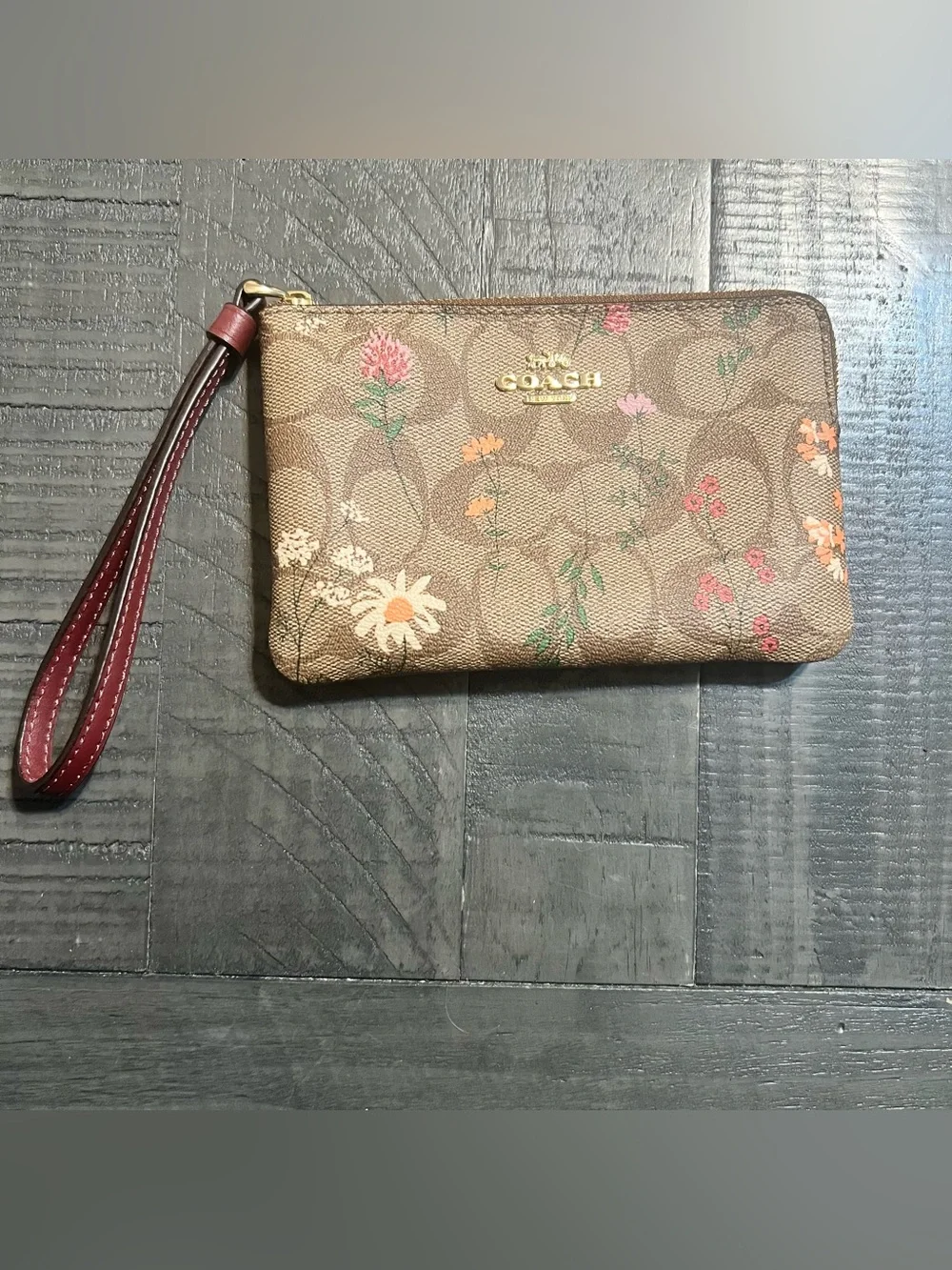 COACH Brown Floral Signature Wristlet with Burgundy Strap
